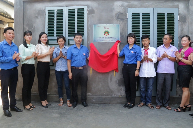 Đồng chí Vũ Thị Diệu Linh, Phó Bí thư Thường trực tỉnh đoàn, Chủ tịch hội đồng Đội tỉnh cùng đại biểu đại biểu gắn biển công trình ngôi nhà khăn quàng đỏ