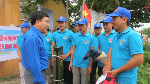 Đồng chí Nguyễn Mạnh Dũng, Bí thư thường trực trung ương Đoàn trao quà và trò chuyện với đội sơ ứng cứu trên tuyến QL1A - Ảnh: Tuyết Khoa
